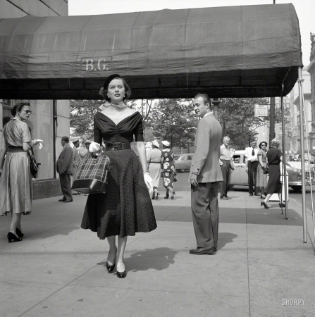 Photo showing: Model Behavior. -- September 1952. New York. Fashion model Doris Erwin walking down Fifth Avenue.