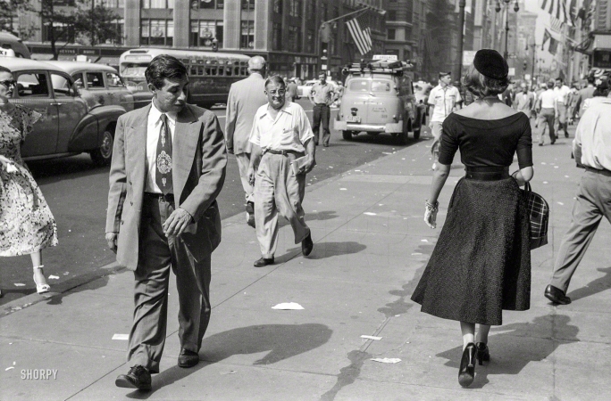 Photo showing: Head-Turner -- New York, September 1952. People looking at fashion model Doris Erwin as she walks down Fifth Avenue.