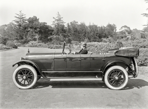 Photo showing: A Feather in Her Cap -- San Francisco circa 1920. Haynes touring car at DeYoung Museum, Golden Gate Park.
