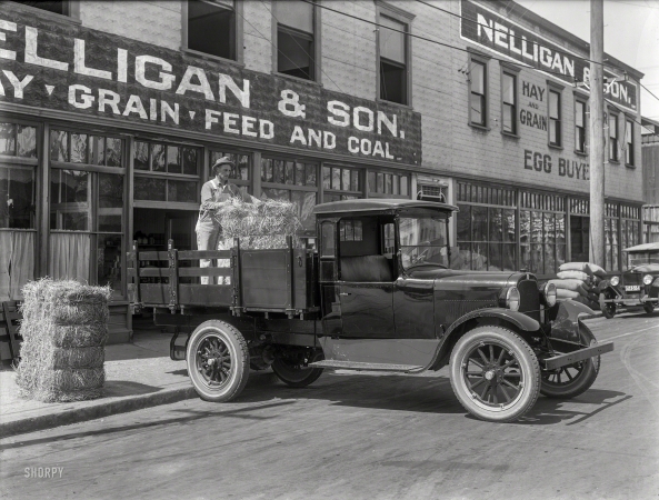 Photo showing: Hay, Grain, Feed and Coal -- Santa Rosa, California, circa 1924. Graham Brothers truck at Nelligan & Son.