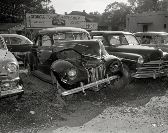 Photo showing: The Defenderers -- Columbus, Georgia, circa 1955. Wrecked Ford.