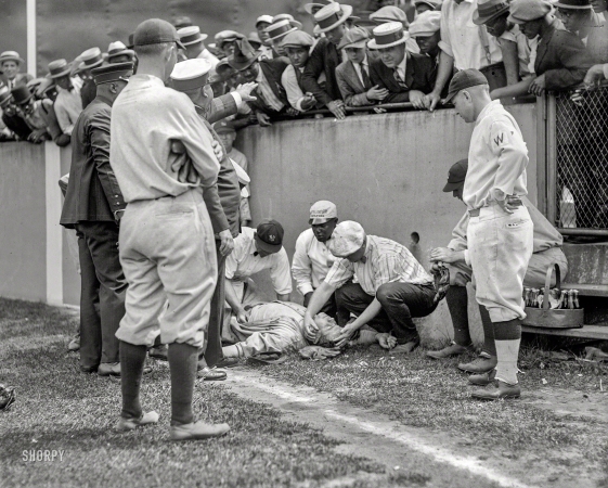 Photo showing: Yer Out! -- Yankees right fielder Babe Ruth knocked unconscious after he ran into a concrete wall at
Griffith Stadium, Washington, D.C., while trying to catch a foul ball on July 5, 1924.