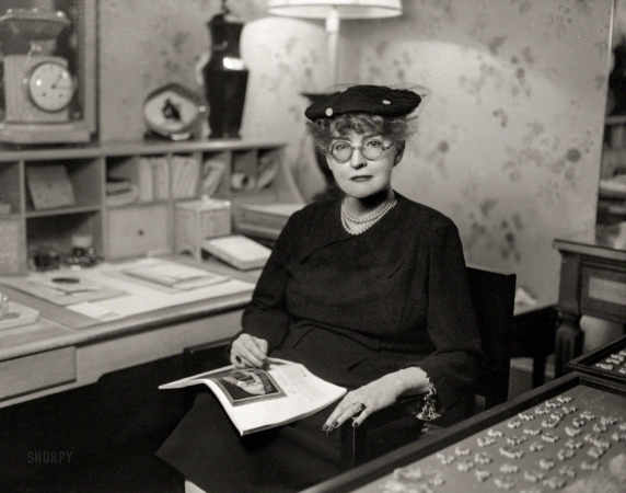 Photo showing: Society Designer -- New York circa 1948. Interior decorator Ruby Ross Wood (1881-1950), seated, at desk.