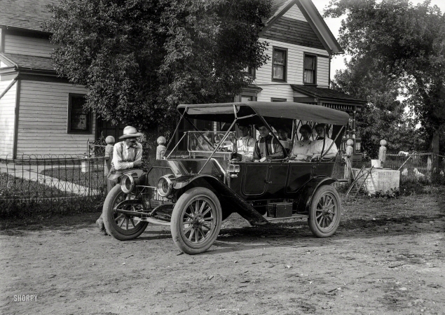 Photo showing: And Away We Go! -- July 10, 1912. Karmnes automobile (Overland touring car). Taken at barn-raising.