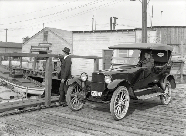 Photo showing: At Anchor -- San Francisco, 1919. Saxon touring car at boatyard.
