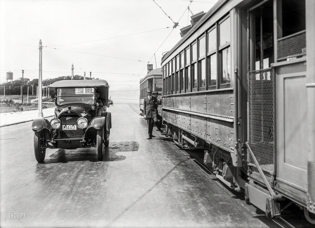 Photo showing: The H Train -- 1919. Cadillac touring car at rail stop. H Line streetcars of the San Francisco Municipal Railway.