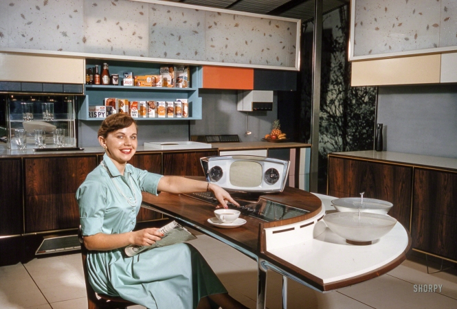 Photo showing: Cafe Jetson -- March 1959. Home economist Anne Anderson demonstrating features of RCA-Whirlpool 'Miracle Kitchen'.