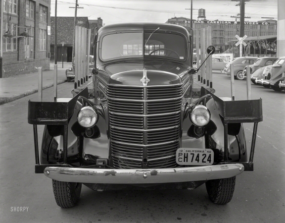 Photo showing: Stakes and a Grille -- San Francisco, 1940. International stake bed truck.