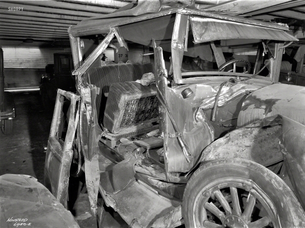 Photo showing: Post-Mortem -- From around 1930 comes this image of a wrecked 1920s Buick and an ominous pair of shoes.