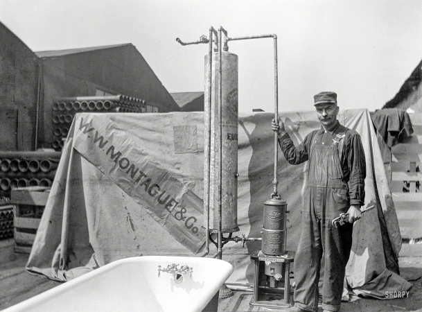 Photo showing: In Hot Water -- San Francisco circa 1910. W.W. Montague & Co. plumber with water heater and bathtub.