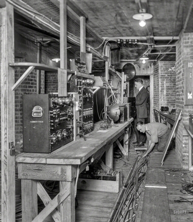 Photo showing: Long Distance -- 1921. This is the delicate machinery being installed beneath the Arlington
Amphitheater which will amplify the President's voice one thousand billion times
when he makes his address on Armistice Day in honor of America's Unknown Warrior.