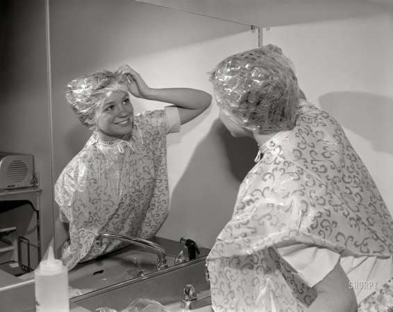 Photo showing: Wrapped in Plastic II -- Columbus, Georgia, circa 1966. One in a series of photos
dealing with cosmetology or hairdressing in a school setting.