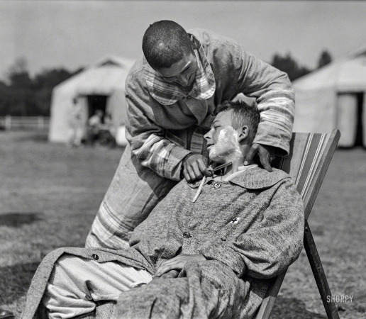 Photo showing: A Close Shave. -- June 1918. A serious operation by the Company Barber. American Military Hospital No. 5 at Auteuil.
