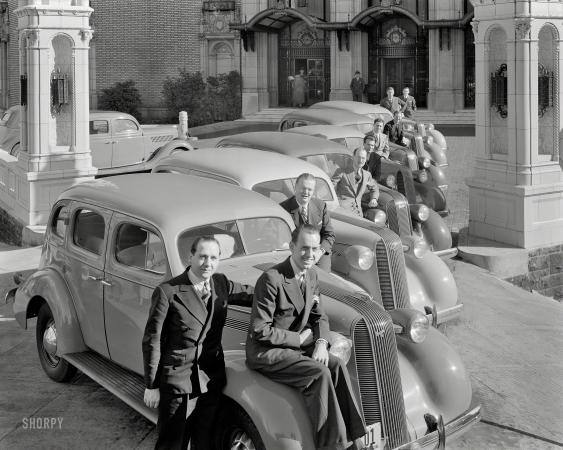 Photo showing: Bottom of the Mark -- 1936 Pontiacs and salesmen at Mark Hopkins Hotel, San Francisco.