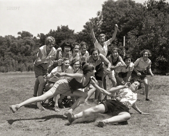 Photo showing: Tagged -- 1930. The big league has nothing on this game. A good action shot of a couple of the girls at the 'Y' camp at Plano, Illinois.