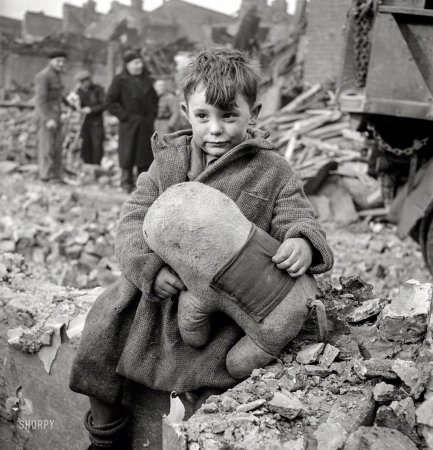 Photo showing: Keep Calm and Carry On -- 1940. Abandoned boy holding a stuffed toy animal amid ruins following German aerial bombing of London.