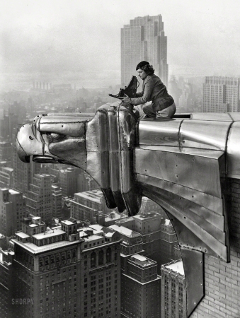 Photo showing: Silver Eagle -- New York circa 1934. Margaret Bourke-White with her camera atop a
stainless steel eagle projecting from the 61st floor of the Chrysler Building.