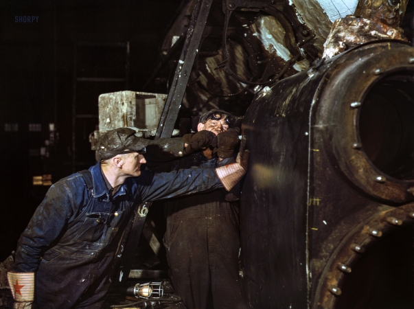 Photo showing: 40th Street Shops -- December 1942. Working on the cylinder of a locomotive at the Chicago & North Western R.R. 40th Street shops, Chicago, Illinois.