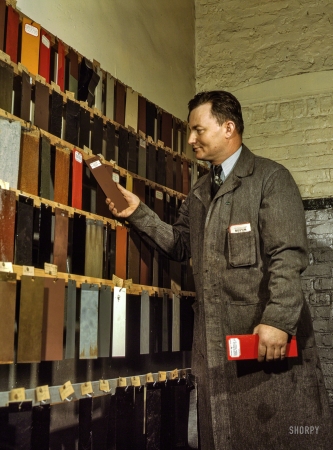 Photo showing: Boxcar Brown -- December 1942. Research laboratory worker at the Chicago & North Western's
40th Street yard, examining paint samples used on freight cars and coaches of the railroad.