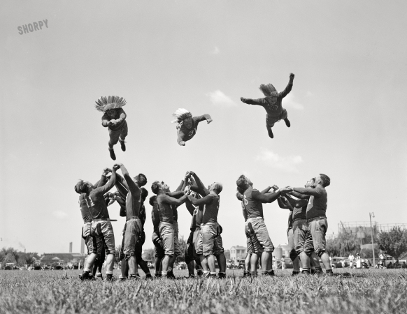 Photo showing: Flying Wedge -- August 28, 1937. Washington Redskins start training. Up in the air: Millner, Rentner, Peterson.