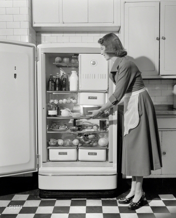 Photo showing: Major Appliance -- New York circa 1948. Woman in kitchen with General Electric refrigerator.