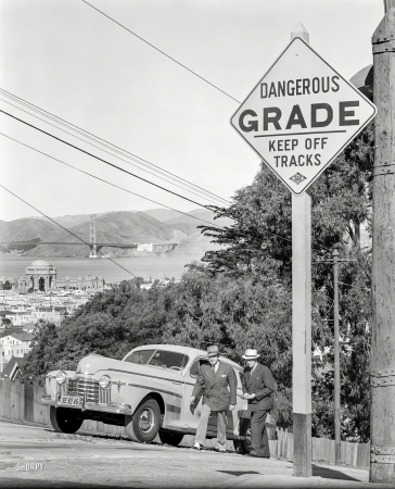 Photo showing: Upward Oldsmobile -- San Francisco, 1940. Oldsmobile sedan and pedestrians ascending steep
grade. With the Palace of Fine Arts and Golden Gate Bridge in the distance. 