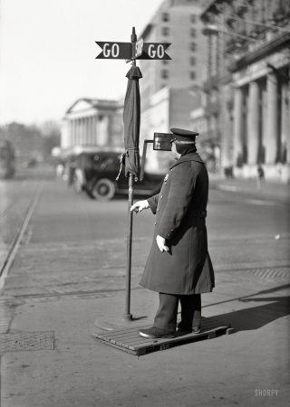 Photo showing: Stop-Stop and Go-Go -- Washington, D.C., circa 1919. Traffic officer at intersection of 14th Street and Pennsylvania Avenue.