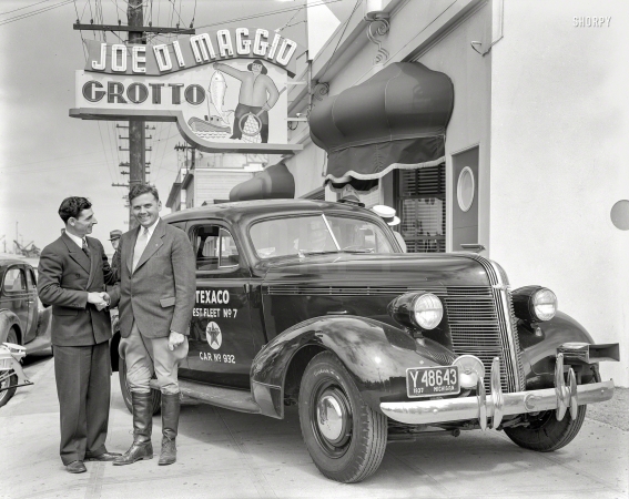 Photo showing: Texaco Test Car -- Fisherman's Wharf in San Francisco, 1937. Texaco Test Fleet auto at
Joe DiMaggio Grotto. Driver of Pontiac with restaurant manager Tom DiMaggio.