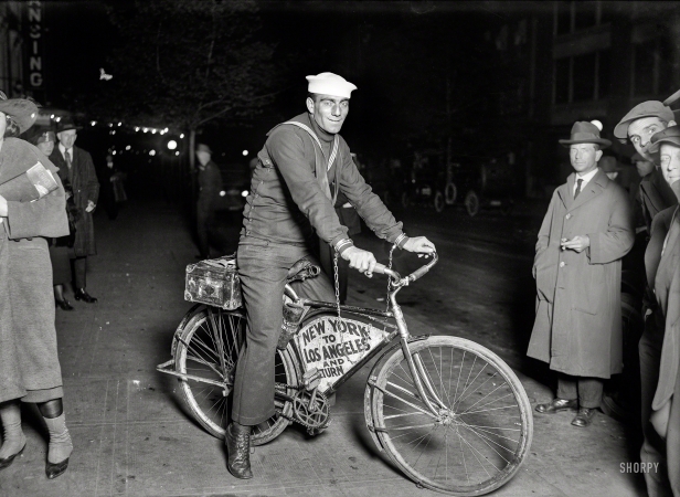 Photo showing: Bike Chained -- May 1920. Sailor Tony Pizzo passing through Washington on a Coast to Coast bicycle run handcuffed to his machine.