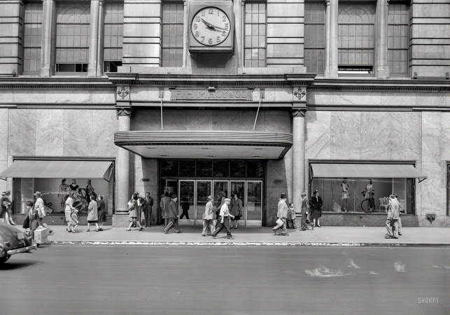 Photo showing: Bicycle on 34th Street -- New York circa 1948. R.H. Macy & Co., street entrance and window displays.