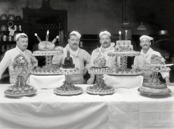 Photo showing: Pastry Parade -- Circa 1920. Set pieces, Arlington Hotel. Including a polar snowball iced with Cook-Peary 1909.