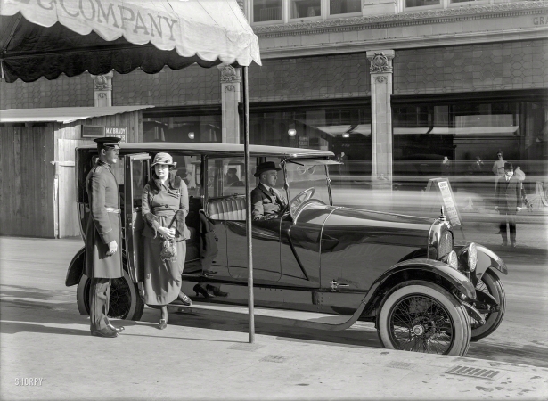 Photo showing: Deaths Doorman -- San Francisco circa 1919. Woman alighting from Marmon limousine.