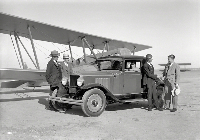 Photo showing: Fast Friends -- San Francisco, 1929. Paige coupe and biplane at Mills Field.