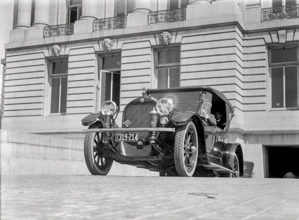 Photo showing: Riding on Air -- San Francisco, 1920. Haynes touring car leaving garage.