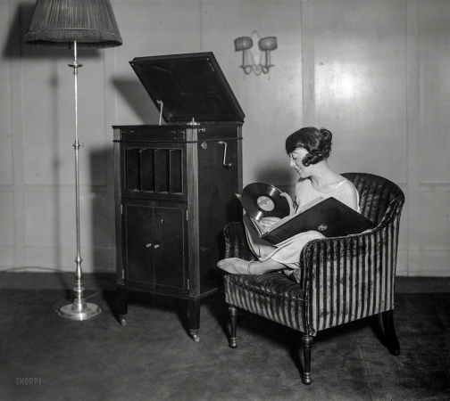 Photo showing: Crank It -- January 3, 1924. New York. Irene Bordoni listening to phonograph.