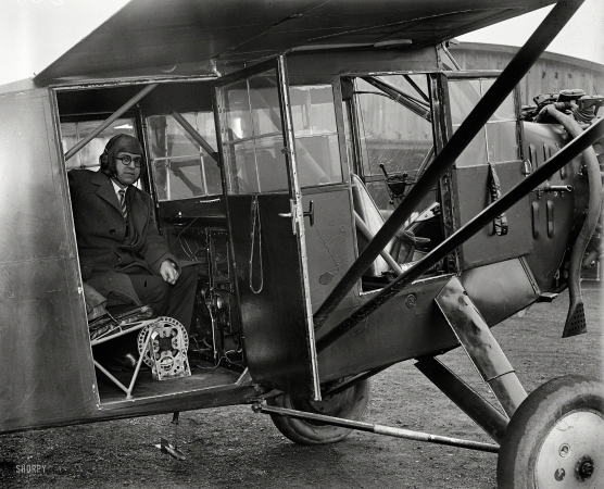 Photo showing: Bombs Away -- 1929. Washington, D.C., or vicinity. Man in airplane.