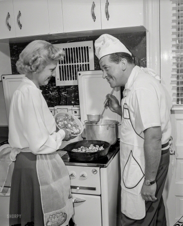 Photo showing: Skillet Dinner. -- Man and woman at stove cooking.