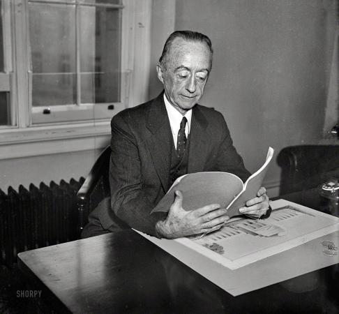 Photo showing: High-Minded -- Washington, D.C., circa 1935. Man at desk with proposal for Jefferson Memorial.