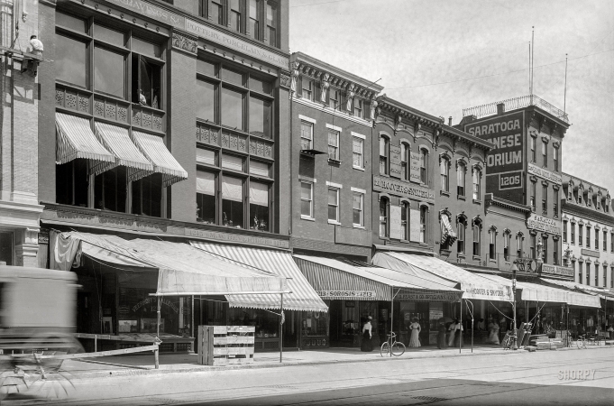 Photo showing: Japanese Emporium -- Washington, D.C., circa 1901. Businesses on F Street N.W., north side, between 12th & 13th Streets.