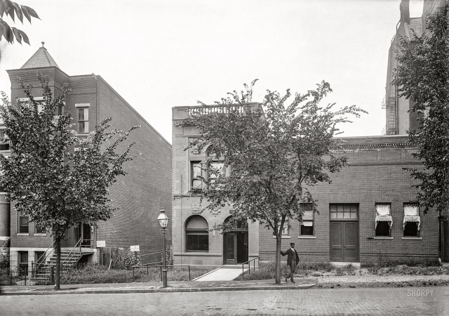 Photo showing: Anonymous Caller -- Washington, D.C., circa 1901. Man standing in front of Chesapeake & Potomac
Telephone Co. on unidentified street; name and address of building obscured by tree.