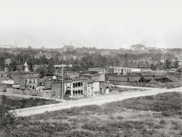 Photo showing: Mourning McKinley -- Washington, D.C. View of H Street S.W., between Half & First Streets, in 1901
showing coal yard and old homes near railroad station. Houses have McKinley memorials ... 