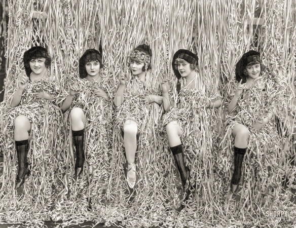 Photo showing: Paper Dolls -- April 1918. Five Mack Sennett girls provocatively posed amid serpentine confetti.