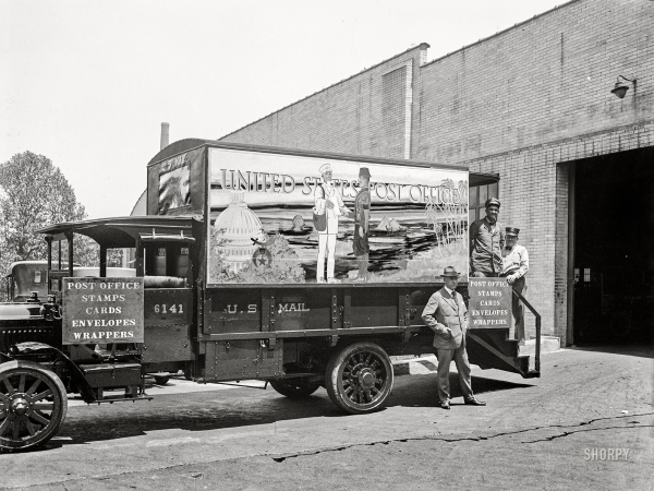 Photo showing: Stamps for Shriners -- May 25, 1923. Post office on wheels decorated with Shrine colors.
Postmaster Wm. M. Mooney is standing before the office.