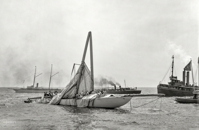Photo showing: Demasted -- August 2, 1899. Sloop Columbia, steel mast carried away.