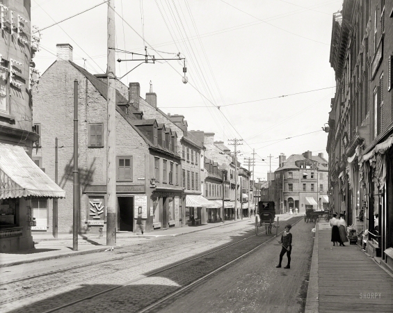 Photo showing: Pharmacy Row -- Circa 1905. Rue Saint-Jean at Côte du Palais in Quebec City, home to the drugstores of P. Mathie and J.E. Livernois.