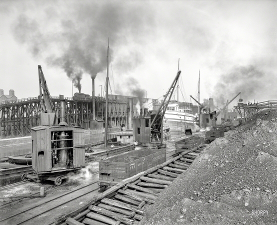 Photo showing: Whirleys Unloading -- Circa 1900. Whirleys unloading ore, Penna. R.R. docks, Erie, Pennsylvania.