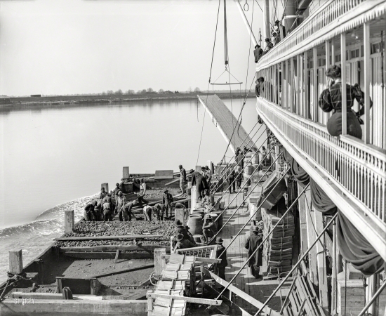 Photo showing: Coaling on the River -- Circa 1906. Coaling a river packet underway on the Mississippi near Memphis.