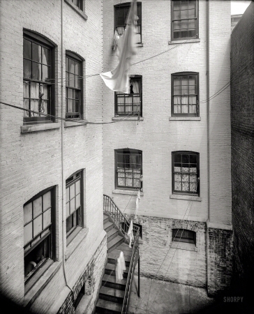 Photo showing: Washday Rigging -- New York circa 1905. Tenement courtyard.