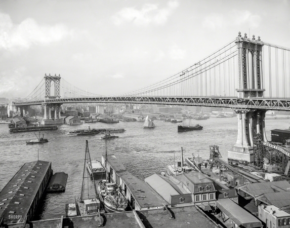 Photo showing: River Traffic -- New York circa 1910. Manhattan Bridge and East River from Brooklyn.