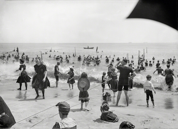Photo showing: On-the-Ropes -- Circa 1910. Surf bathers at crowded beach, possibly Atlantic City.